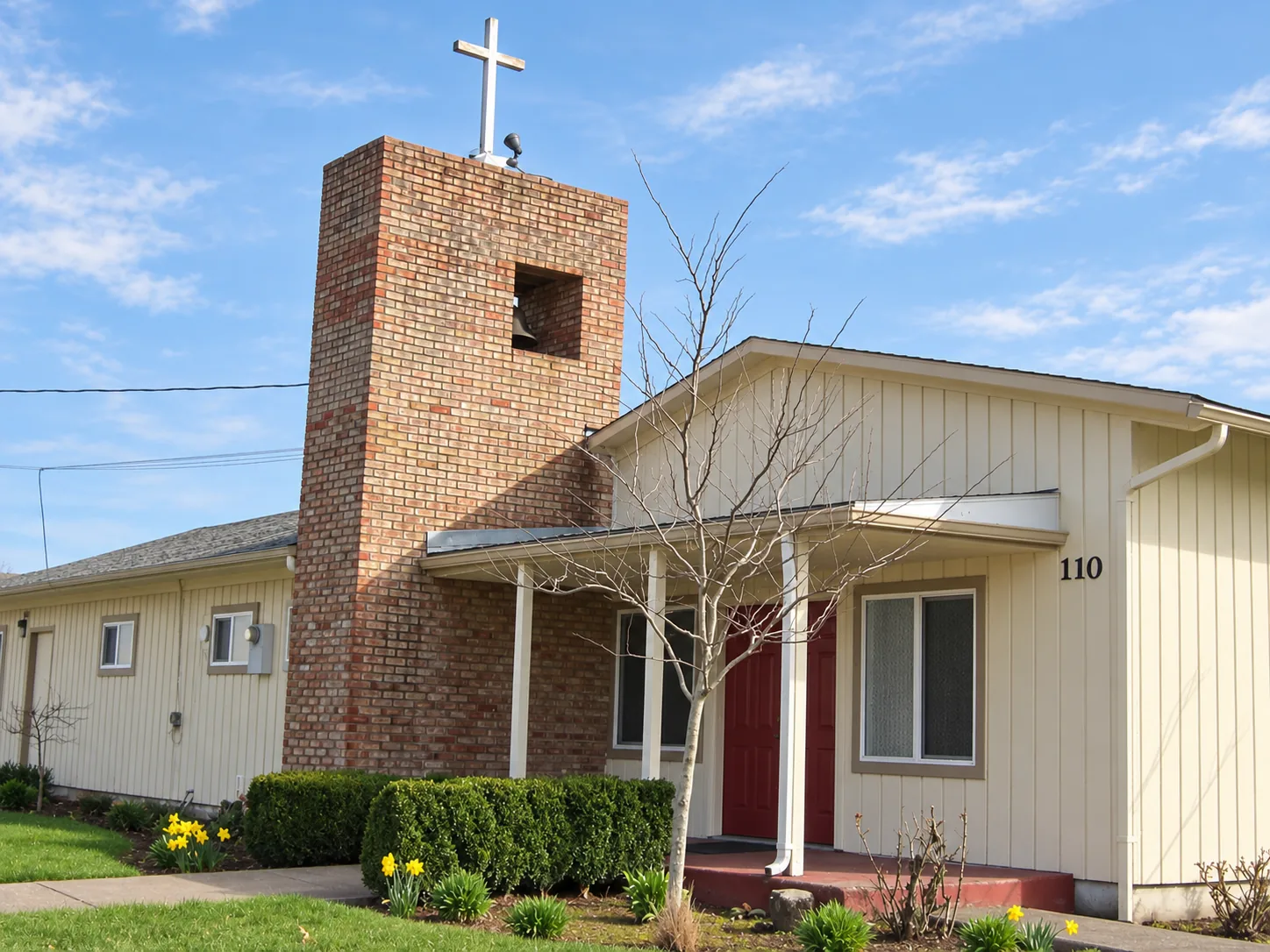 The church entrance and brick bell tower, from the parish photo archive.
